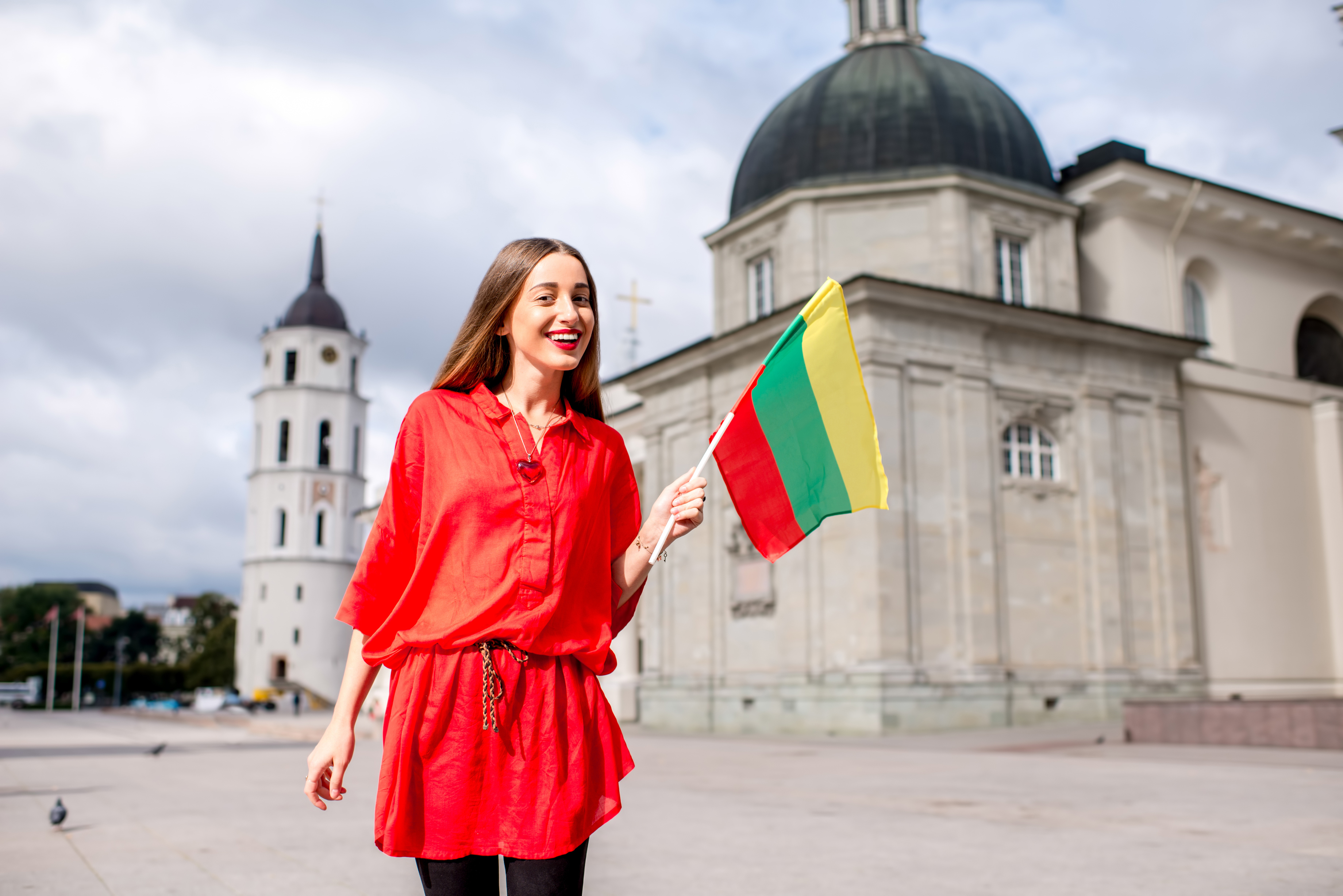 Девушка с флагом Литвы, где для учебы иностранцам надо оформлять студенческую визу